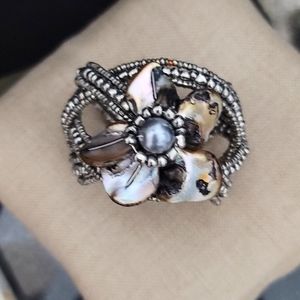 Beaded cuff bracelet with shell blossom